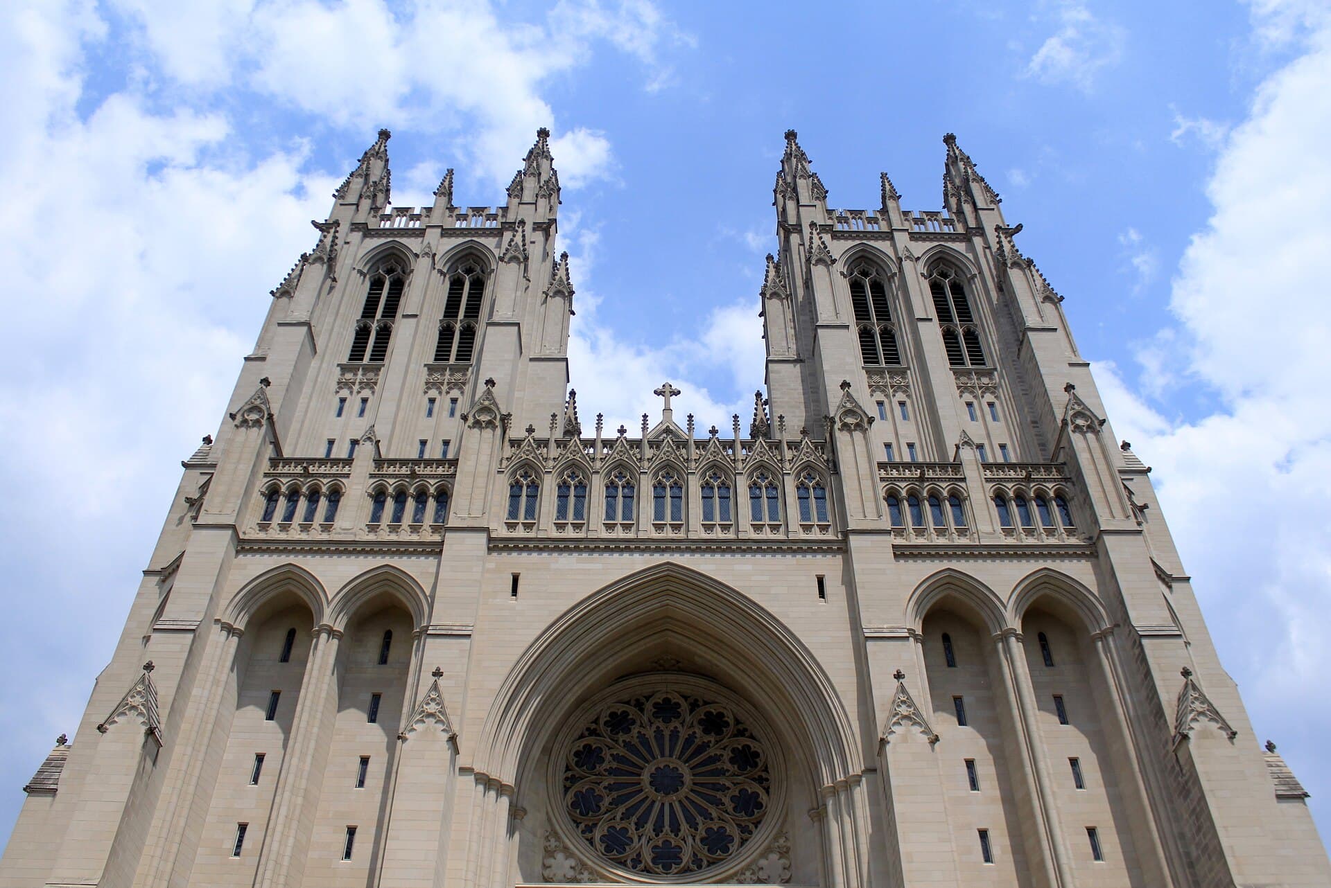 West front and twin towers of Washington National Cathedral beneath a blue sky