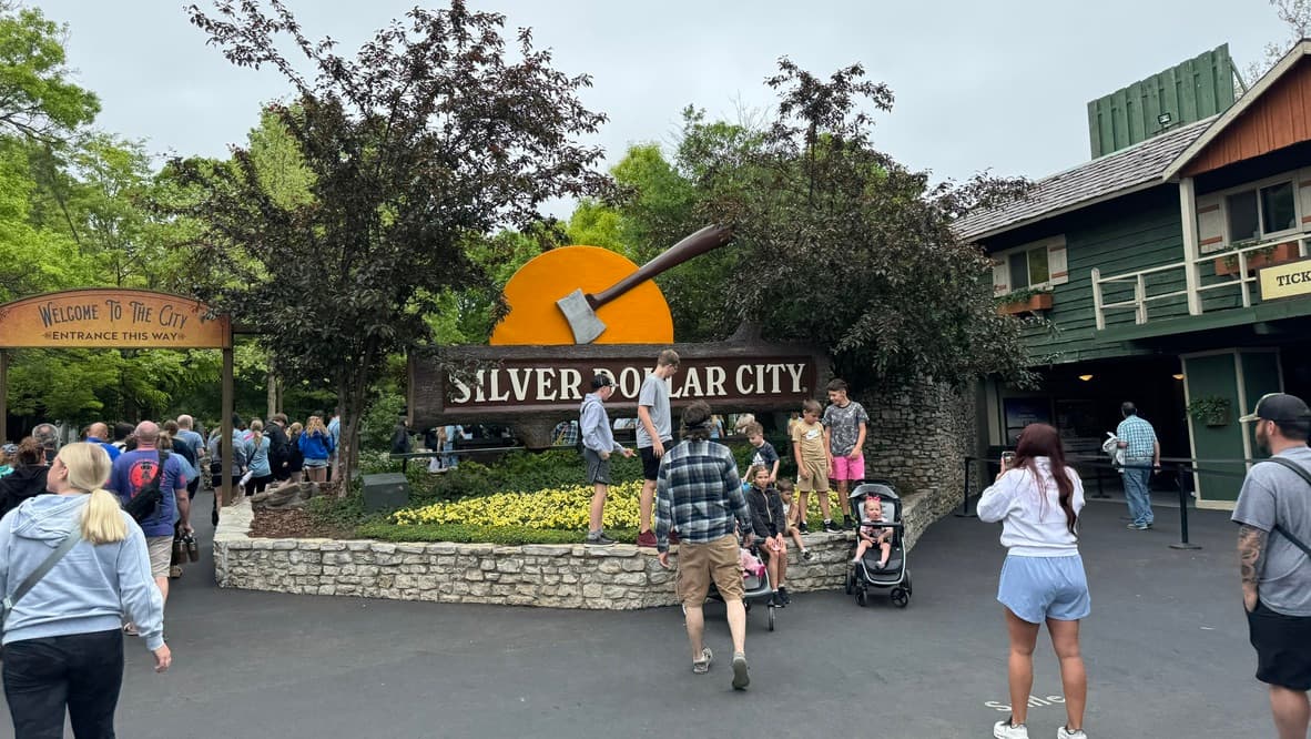 Visitors arriving beneath the Silver Dollar City entrance sign