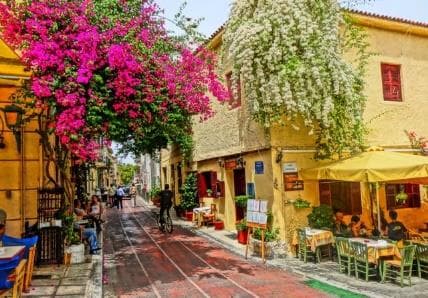 A flower-filled pedestrian street with outdoor dining in Plaka, Athens
