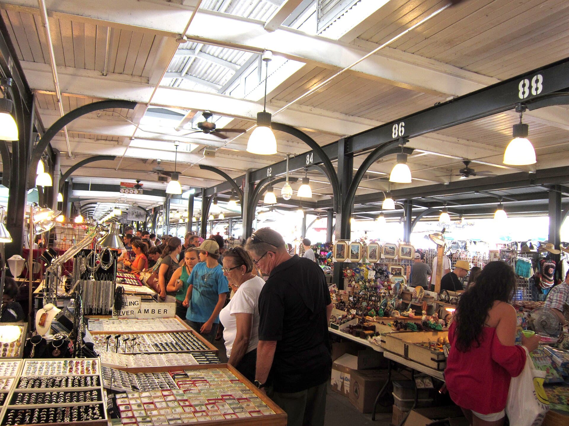 Shoppers browsing stalls under the arcade of the historic French Market