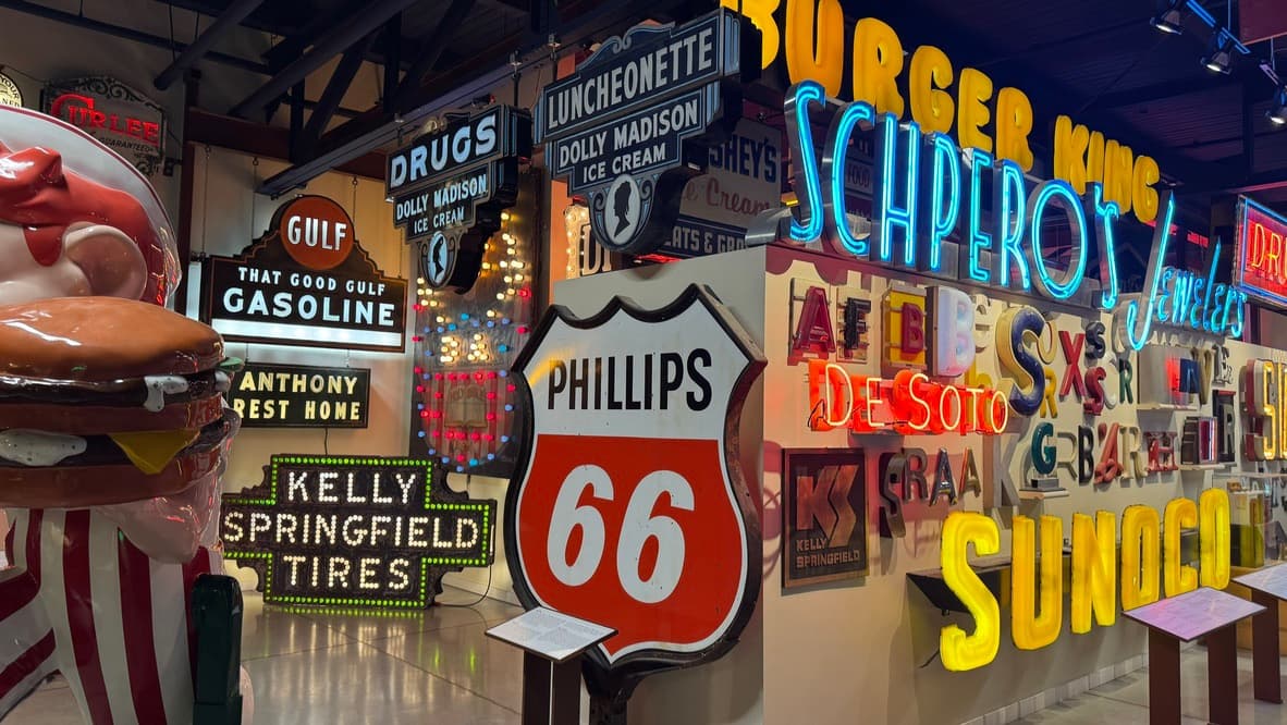 Walls of restored American signs, from painted panels to neon, inside the American Sign Museum