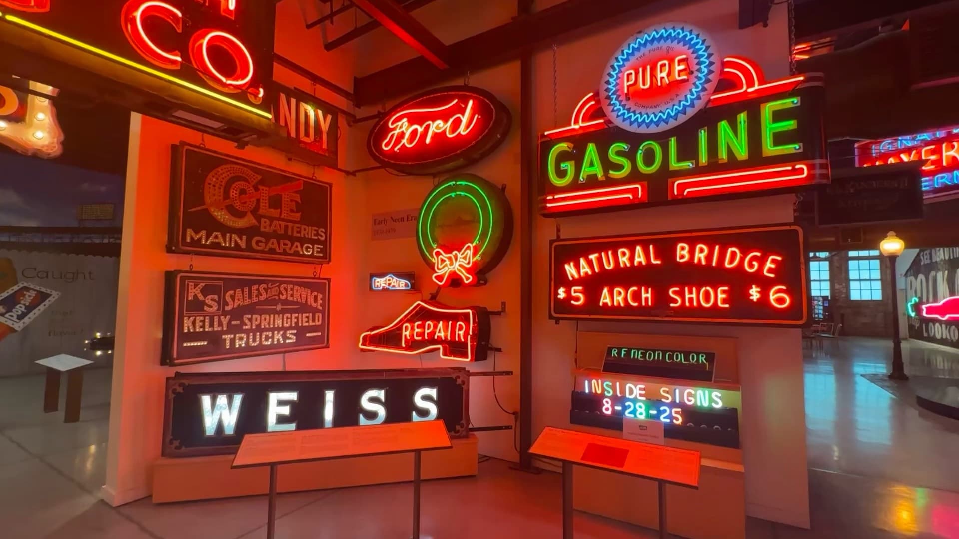 Restored Ford, Pure Gasoline, and early neon signs glowing inside the American Sign Museum