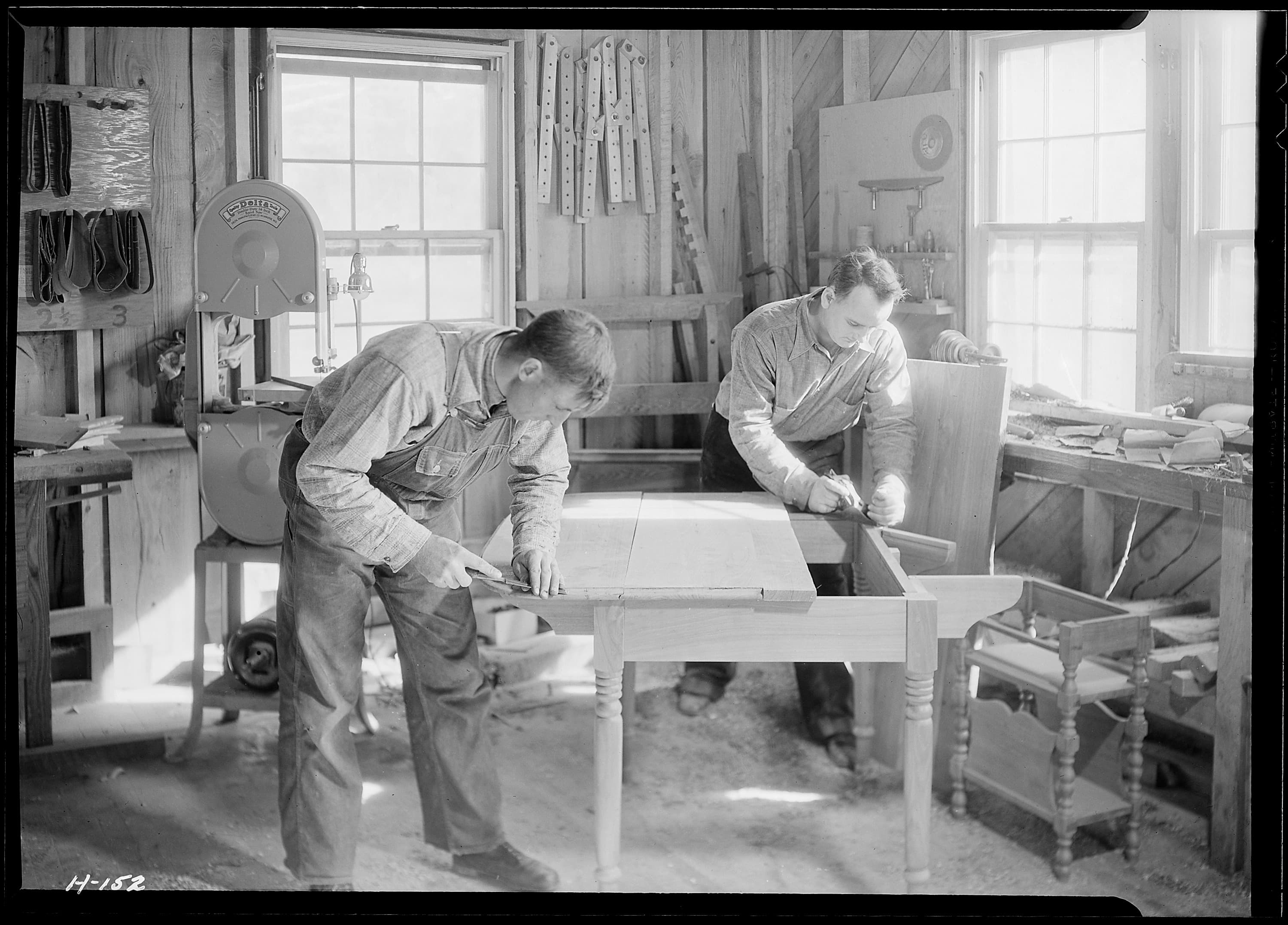 Two Gatlinburg woodworkers shaping furniture in their workshop in 1933