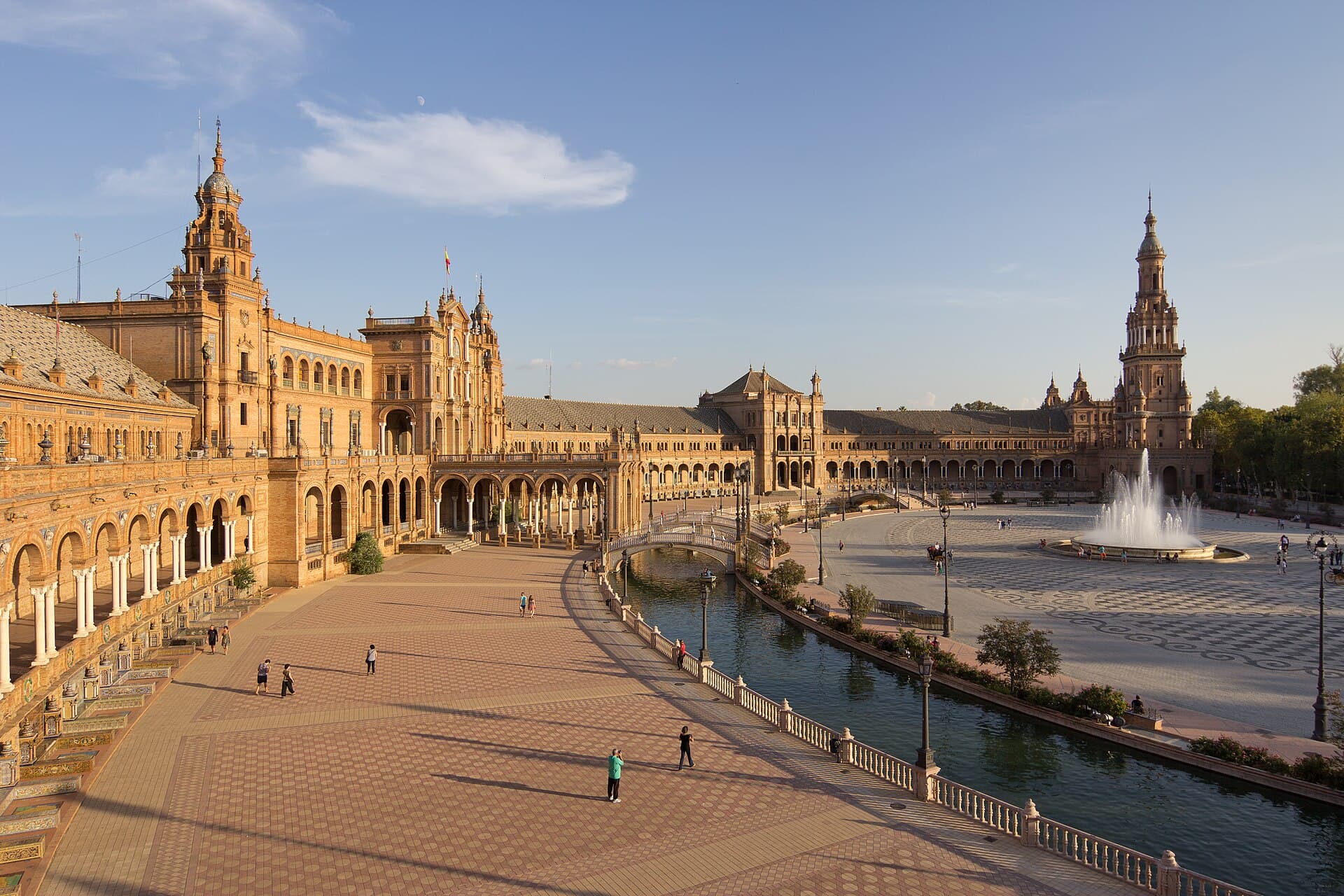 Plaza de España in Seville with its canal, bridges, and fountain at golden hour