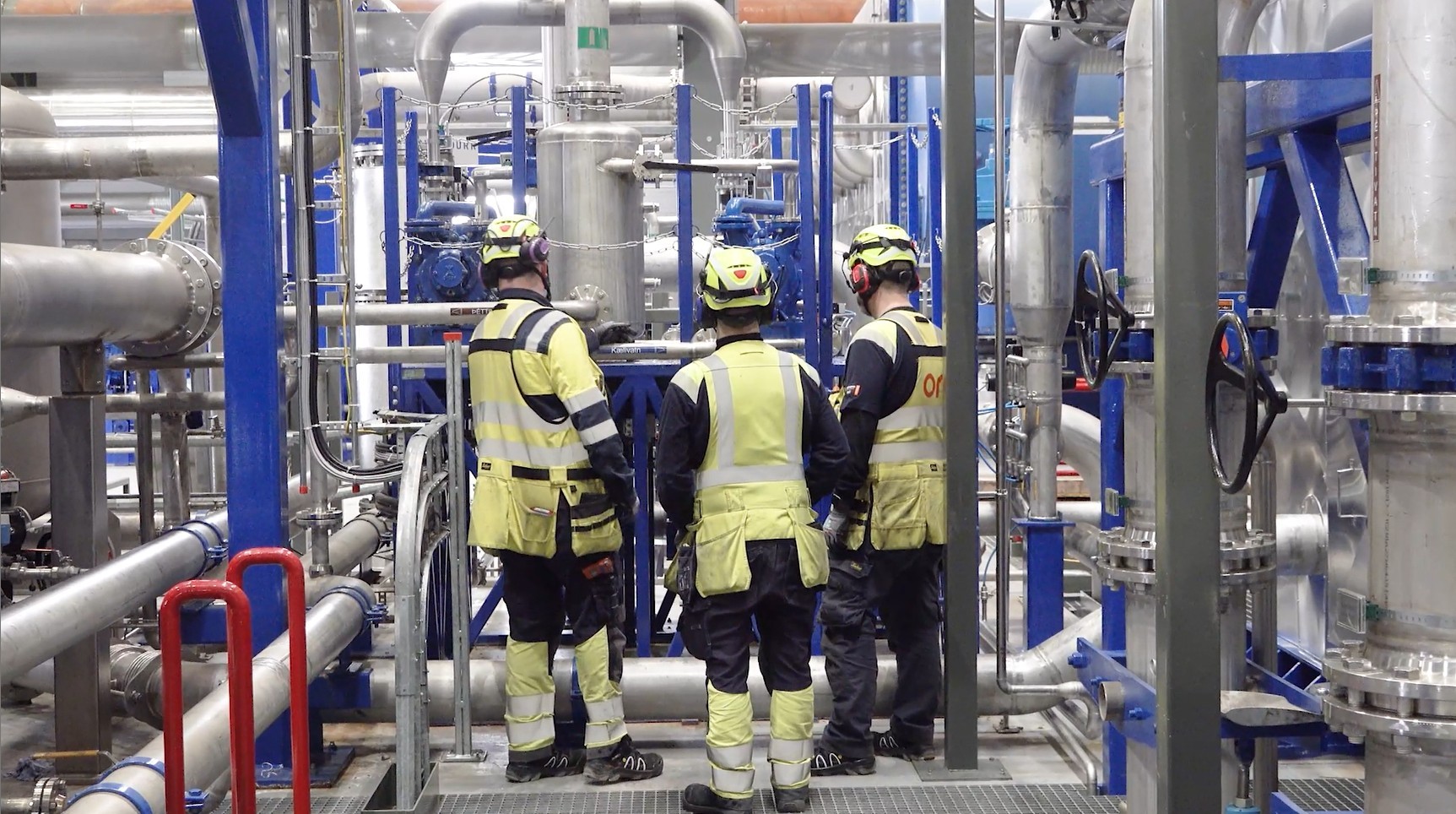 ON Power technicians surrounded by industrial pipes and geothermal equipment inside Hellisheiði Power Plant