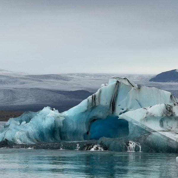 A blue iceberg in a glacier lagoon